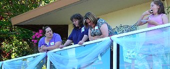 Andrea in blue shirt between cousins Theresa and Sandy. Daughter Demetria is off to the left eating cake.