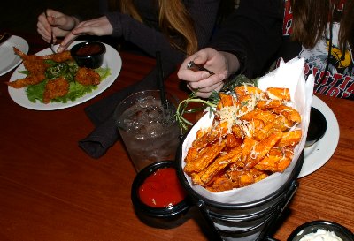 Fried sweet potatoes with coconut prawns in the background - photo.