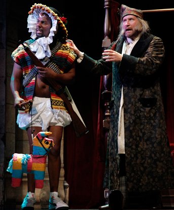 Reginald Andre Jackson with his Mexican Christmas pinata and Ian Bell in Inspecting Carol at Seattle Rep. Photo by Chris Bennion.