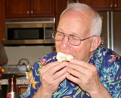 Mike eating a cupcake from Burning Cupcakes.