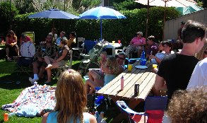 An overflowing backyard party of revelers.