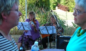 Deb Irwin and Nancy Knudsen deep in talk with Barb and Jan performed.