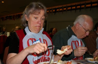 Jan Runbeck eating crab at the Totem Yacht Club fundraiser - photo.