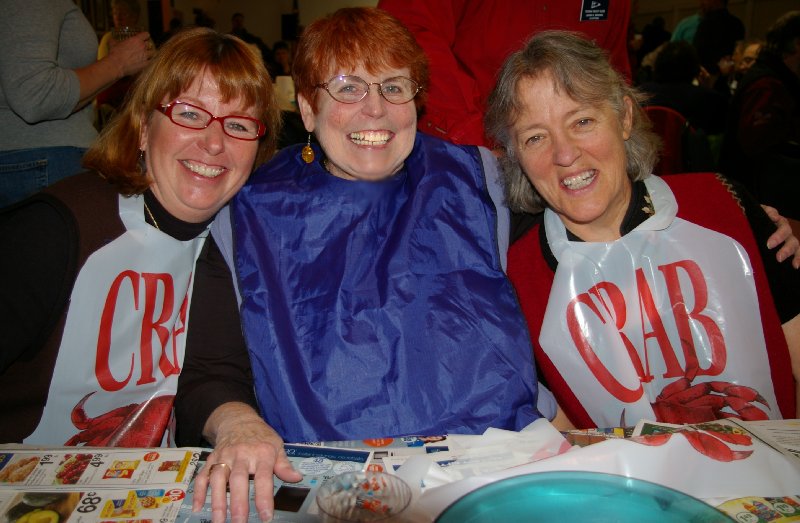 Debbie Irwin, Peg Doman and Jan Runbeck enjoying themselves at the Totem Yacht Club crab feed fundraiser - photo.