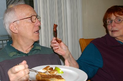 Peg feeding Mike pepper bacon - Ocean Shores Washington Adventure.