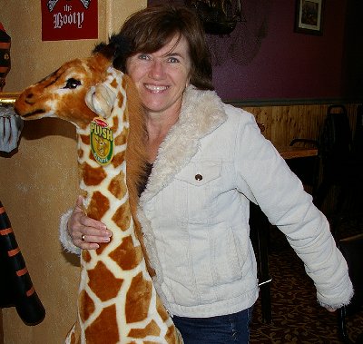 Vickie riding a giraffe - Ocean Shores Washington Adventure.