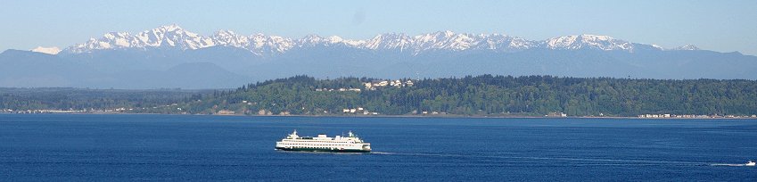 A view of the Kingston Ferry and the Olympic Mountains from Edmonds, Washington.