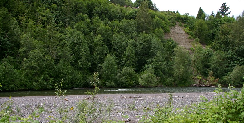 The Puyallup River and bluff rising over the High Cedars Golf Club in Orting, Washington.