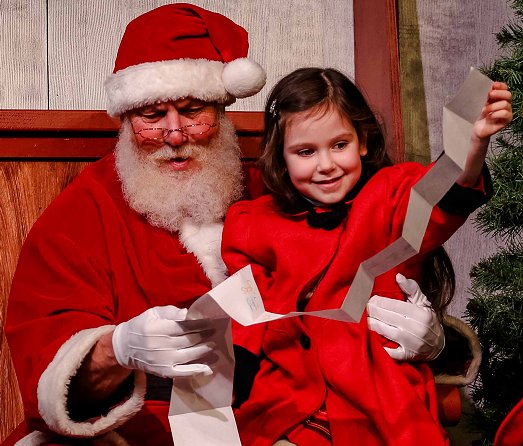 Kris Kringle played by Michael Dresdner, and Janet played by Violet Brielle Spatary at Tacoma Little Theatre - Photo courtesy Dennis K Photography - image.