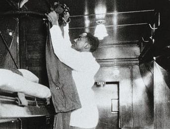 A Pullman porter making up a bed.