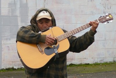 A local entertainer plays guitar in welcome to the Star Lite Swap Meet.