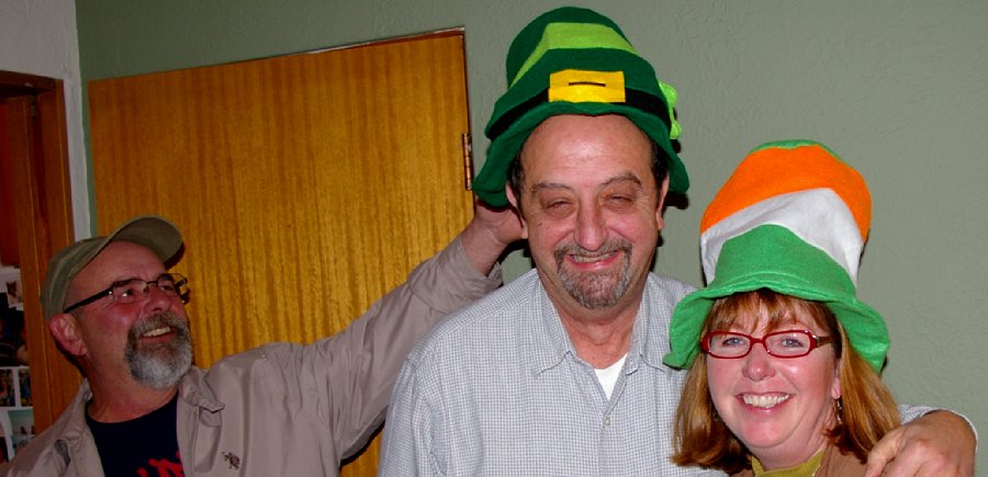 Randy headslaps Donn and Donn and Debbie wear St. Patrick's Day Party hats supplied by Jan Runbeck - photo.