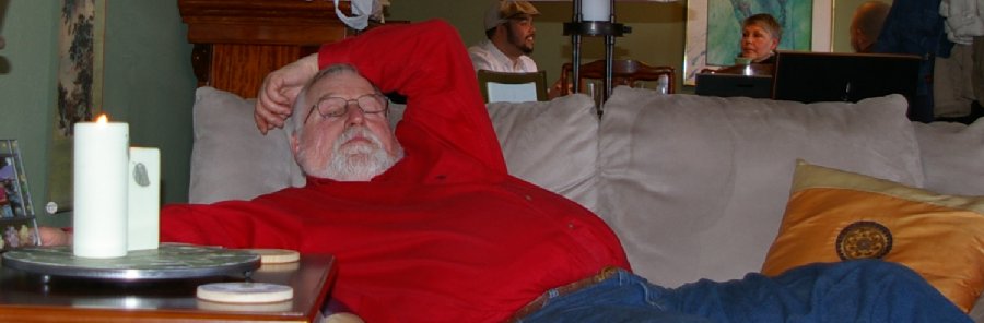 John relaxing on the couch and watching TV - photo.