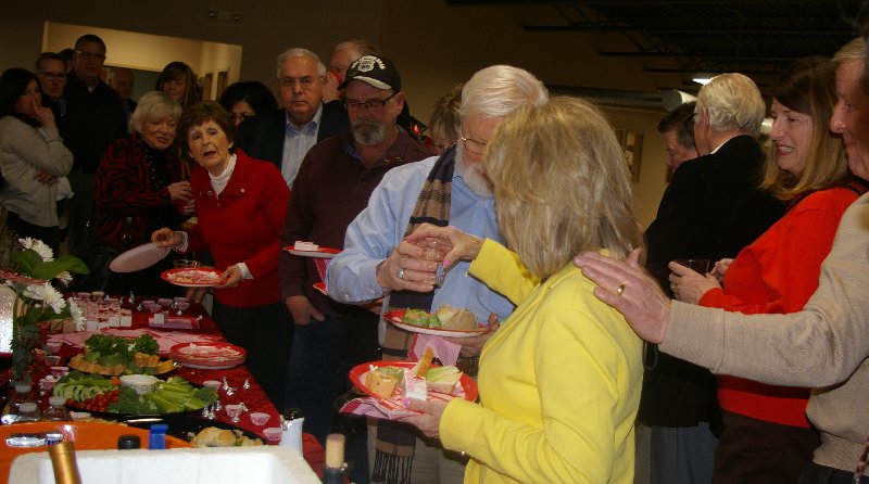 Mike and Dana Jones in the buffet line with Jim Merritt looks for cuts at Ted Brown Music in Tacoma - image.