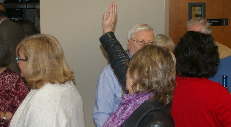 Sue Lord waves to friends across the room at Ted Brown Music in Tacoma - image.