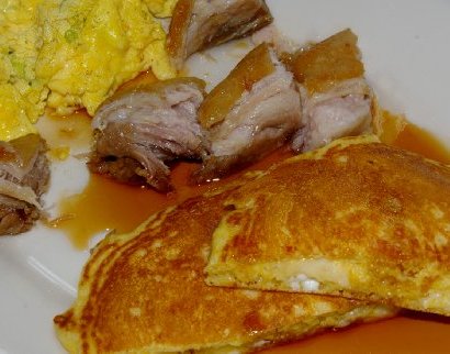 Corn and mozzarella pancakes with pork belly and scrambled eggs at the Americana Restaurant in Seattle.