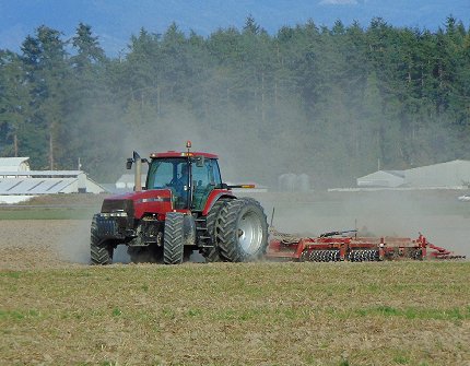 Tractor tilling the fields near LaConner, Washington - image.