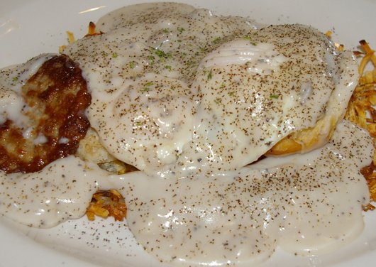 Hash browns, sausage, biscuit, fried eggs, and gravy in Tacoma - image.