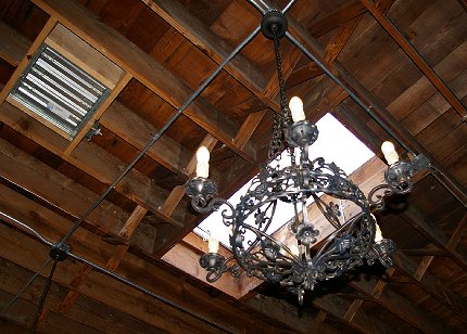 Hanging light fixture right below a skylight at the Manhattan Steakhouse in Seattle - image.