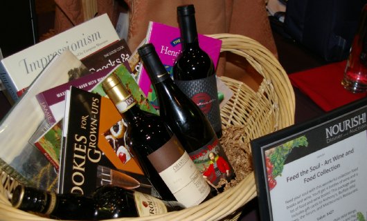 Fine dining and art auction basket at Nourish FISH Auction in Tacoma, Washington - image.