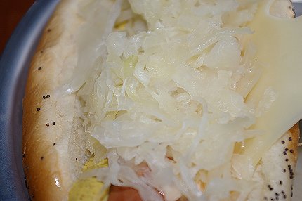 Hot dog with sauerkraut and Swiss cheese - image.