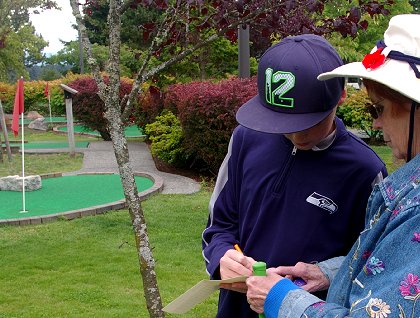 Adding up scores for miniature golf at Tacoma Firs Golf Center - image.